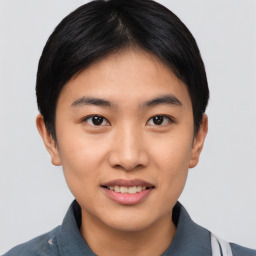 Joyful asian young-adult female with short  black hair and brown eyes