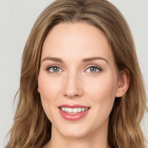 Joyful white young-adult female with long  brown hair and green eyes