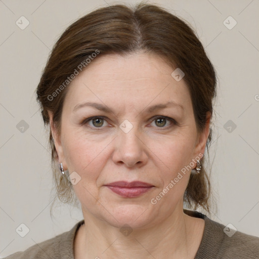 Joyful white adult female with medium  brown hair and grey eyes