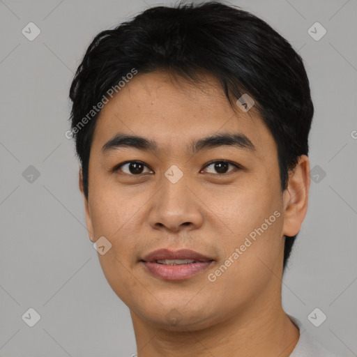 Joyful asian young-adult male with short  black hair and brown eyes