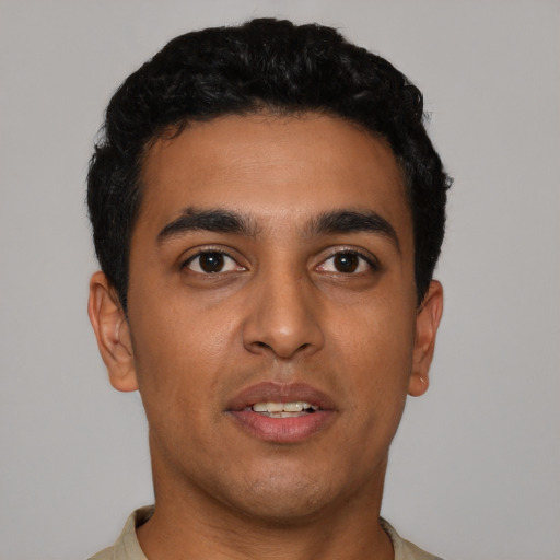 Joyful latino young-adult male with short  black hair and brown eyes