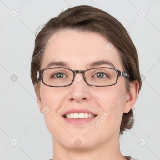 Joyful white young-adult female with medium  brown hair and green eyes