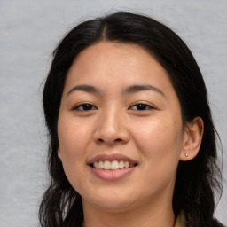 Joyful asian young-adult female with long  brown hair and brown eyes