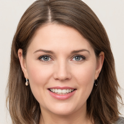 Joyful white young-adult female with medium  brown hair and grey eyes