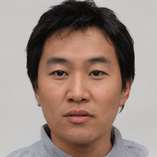 Neutral asian young-adult male with short  black hair and brown eyes