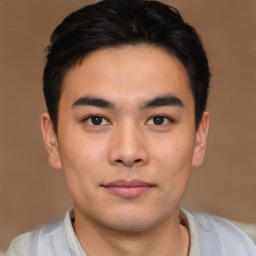 Joyful asian young-adult male with short  black hair and brown eyes