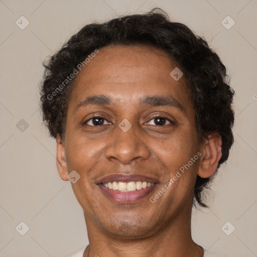 Joyful black adult male with short  brown hair and brown eyes