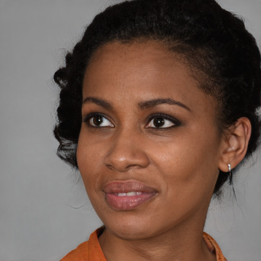 Joyful black young-adult female with medium  black hair and brown eyes