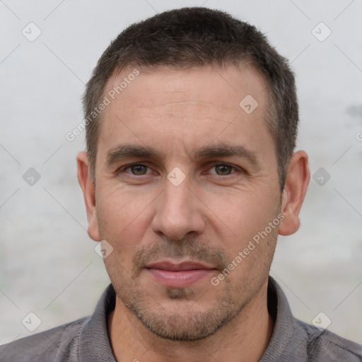 Joyful white adult male with short  brown hair and brown eyes