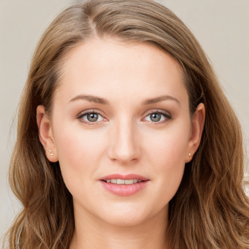 Joyful white young-adult female with long  brown hair and blue eyes