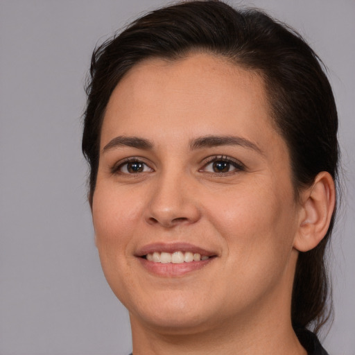 Joyful white young-adult female with medium  brown hair and brown eyes