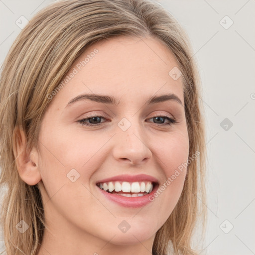 Joyful white young-adult female with long  brown hair and green eyes