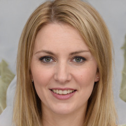 Joyful white young-adult female with long  brown hair and green eyes