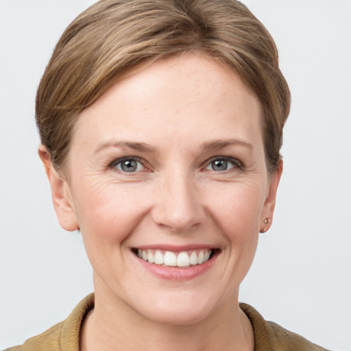 Joyful white young-adult female with short  brown hair and grey eyes