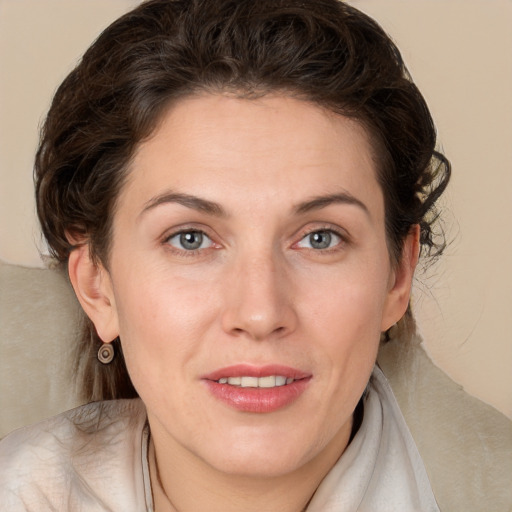 Joyful white adult female with medium  brown hair and grey eyes