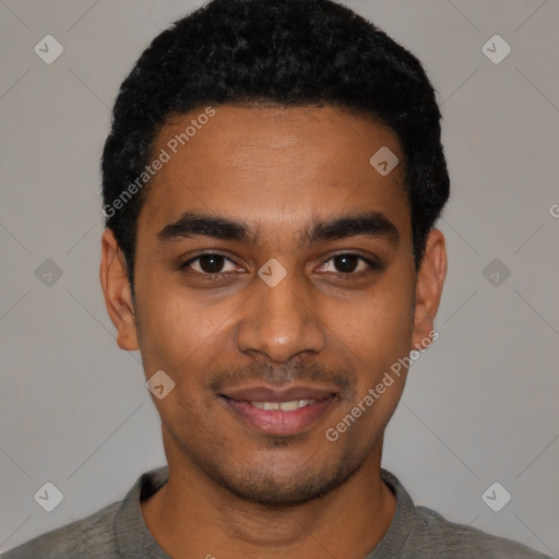 Joyful black young-adult male with short  black hair and brown eyes