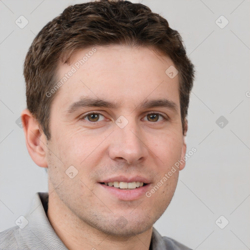 Joyful white young-adult male with short  brown hair and grey eyes