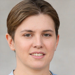 Joyful white young-adult female with short  brown hair and grey eyes