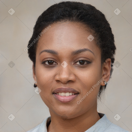 Joyful black young-adult female with short  black hair and brown eyes