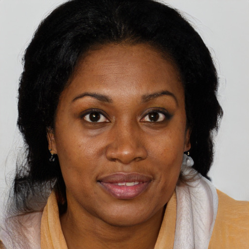 Joyful black adult female with medium  brown hair and brown eyes