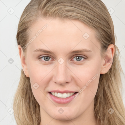 Joyful white young-adult female with long  brown hair and blue eyes