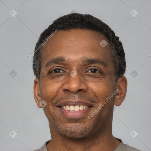 Joyful latino adult male with short  black hair and brown eyes