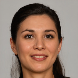 Joyful white young-adult female with medium  brown hair and brown eyes