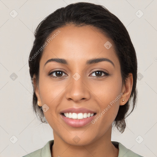 Joyful latino young-adult female with medium  brown hair and brown eyes