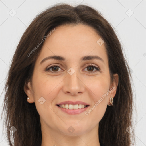 Joyful white adult female with long  brown hair and brown eyes