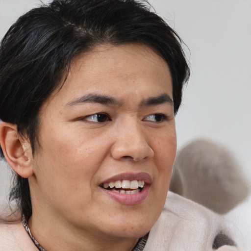 Joyful asian young-adult male with medium  brown hair and brown eyes