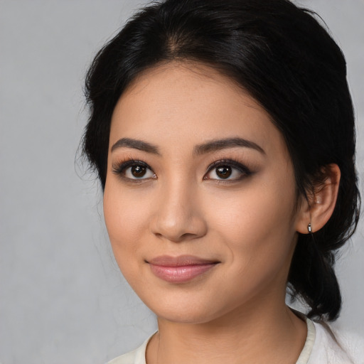 Joyful latino young-adult female with medium  black hair and brown eyes