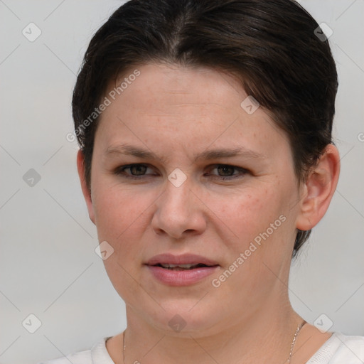 Joyful white young-adult female with short  brown hair and grey eyes