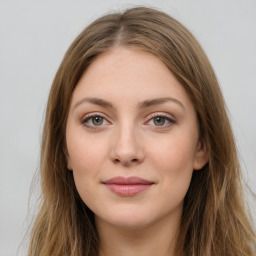 Joyful white young-adult female with long  brown hair and green eyes