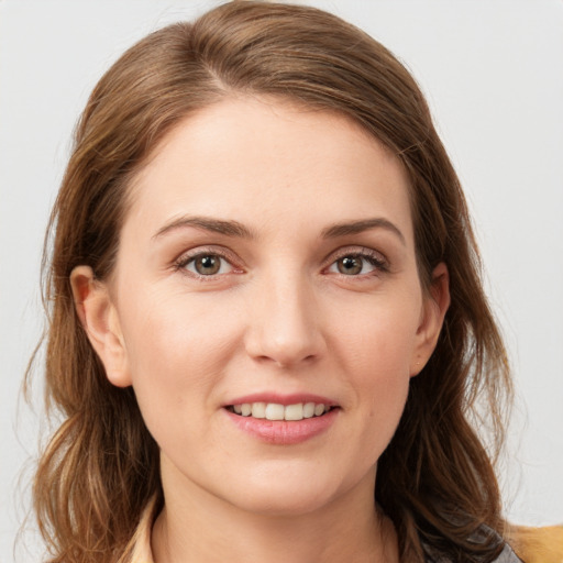 Joyful white young-adult female with medium  brown hair and grey eyes