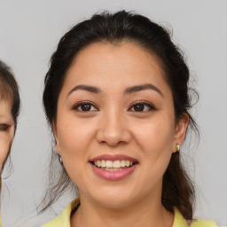 Joyful latino young-adult female with medium  brown hair and brown eyes