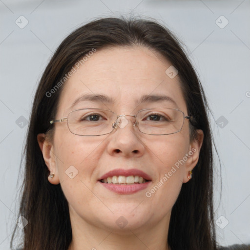 Joyful white adult female with long  brown hair and brown eyes