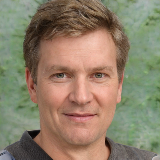 Joyful white adult male with short  brown hair and grey eyes