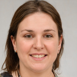 Joyful white young-adult female with medium  brown hair and grey eyes