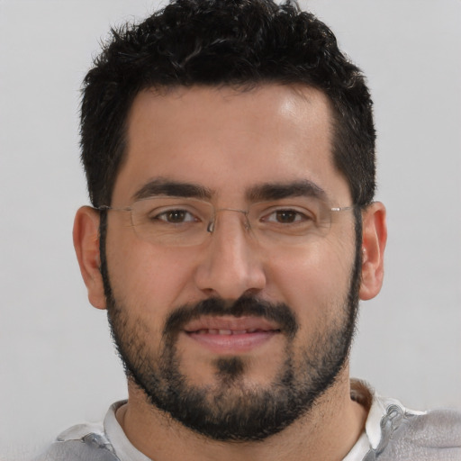 Joyful white young-adult male with short  black hair and brown eyes