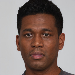 Neutral black young-adult male with short  black hair and brown eyes