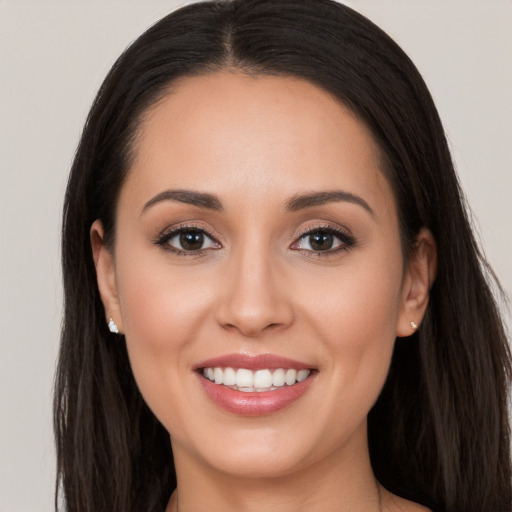 Joyful white young-adult female with long  brown hair and brown eyes