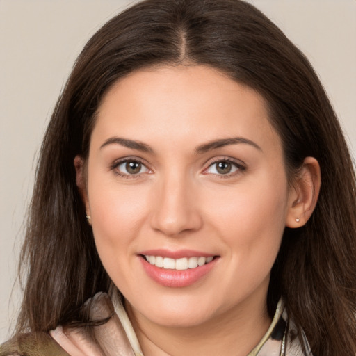 Joyful white young-adult female with long  brown hair and brown eyes