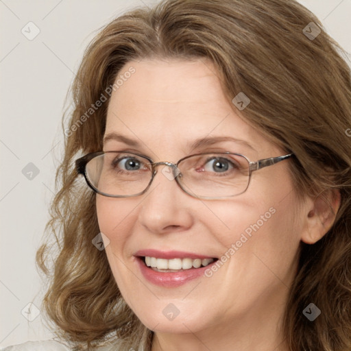 Joyful white adult female with medium  brown hair and blue eyes