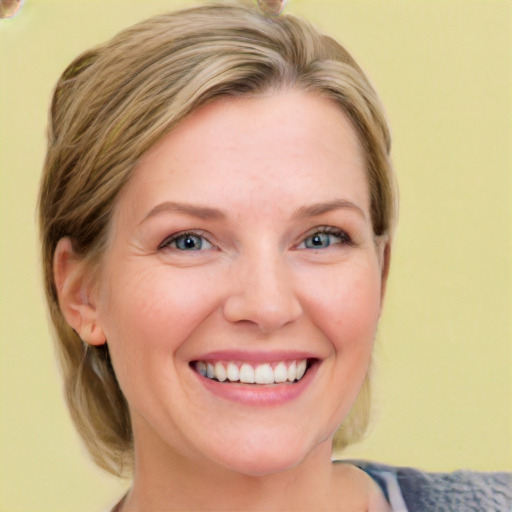 Joyful white young-adult female with medium  brown hair and blue eyes