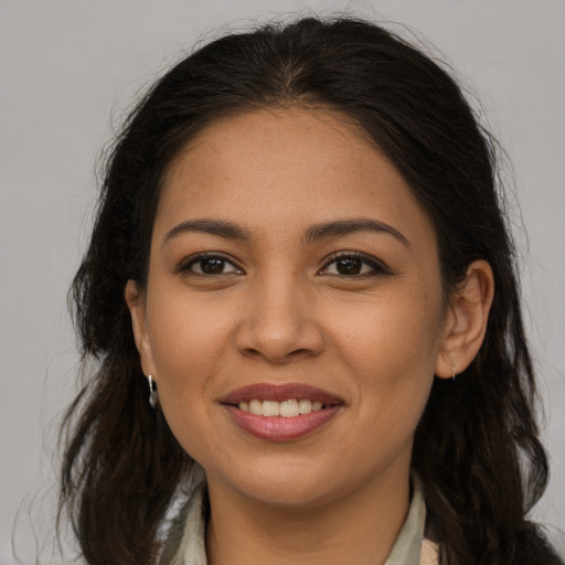 Joyful latino young-adult female with long  brown hair and brown eyes