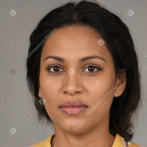 Joyful latino adult female with medium  brown hair and brown eyes