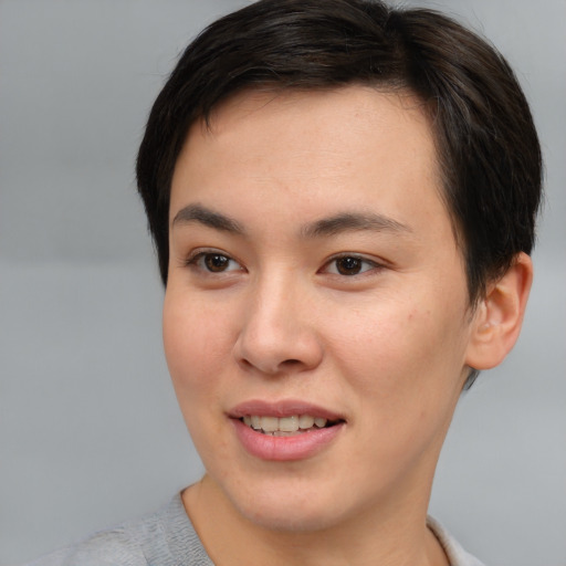 Joyful asian young-adult female with short  brown hair and brown eyes