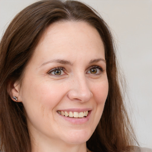 Joyful white young-adult female with long  brown hair and grey eyes