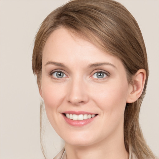 Joyful white young-adult female with long  brown hair and blue eyes