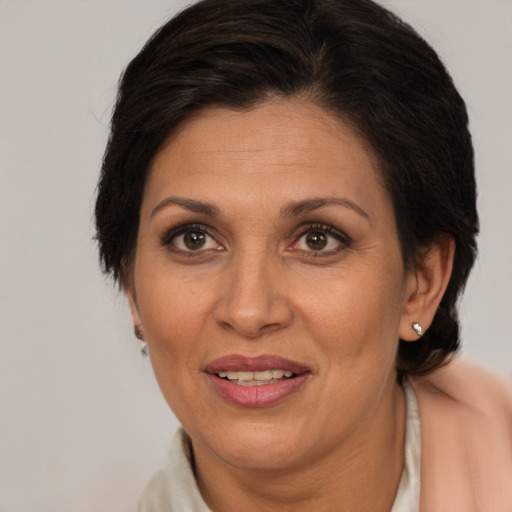 Joyful white adult female with medium  brown hair and brown eyes